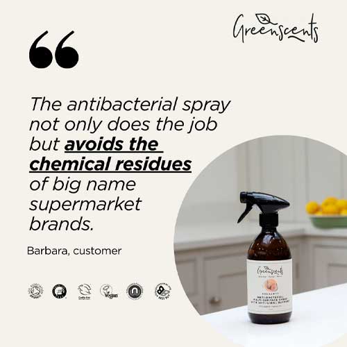 greenscents Antibacterial spray bottle with text about avoiding chemical residues, displayed on a kitchen counter.