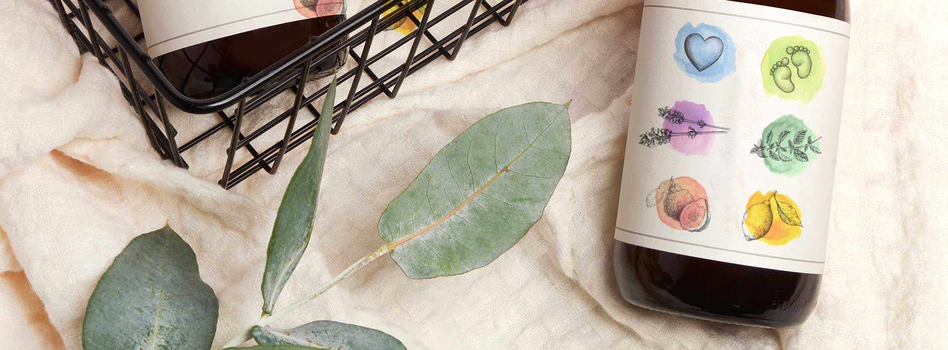 greenscents bottle with decorative label on a textured surface with leaves