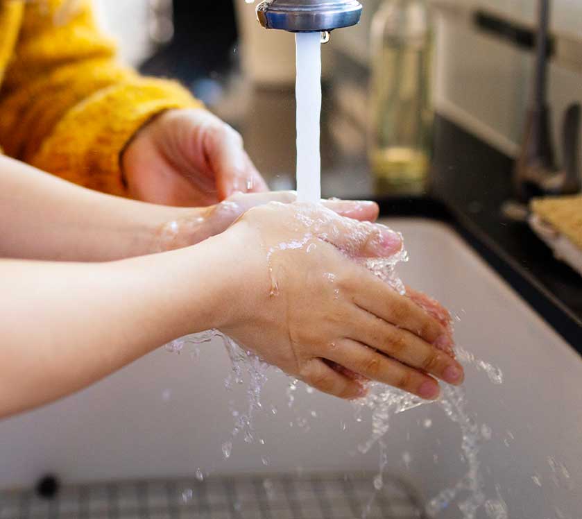 washing hands in sink
