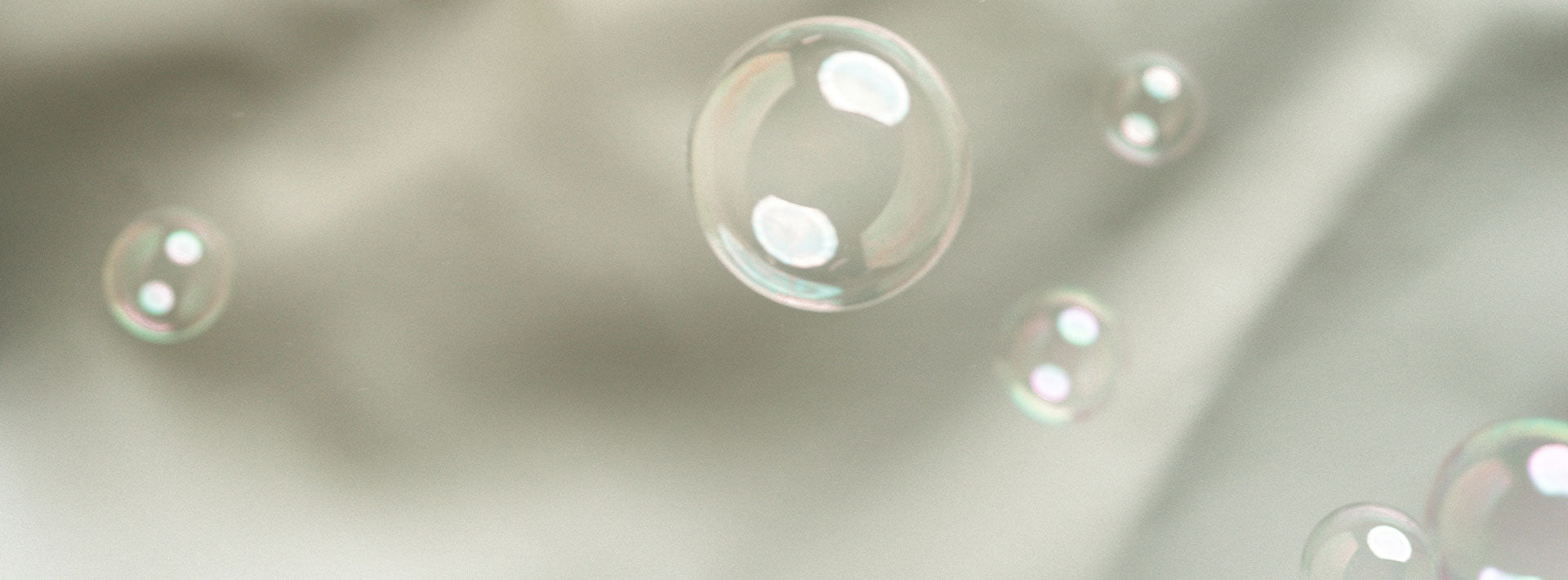 Transparent bubbles on a beige fabric background