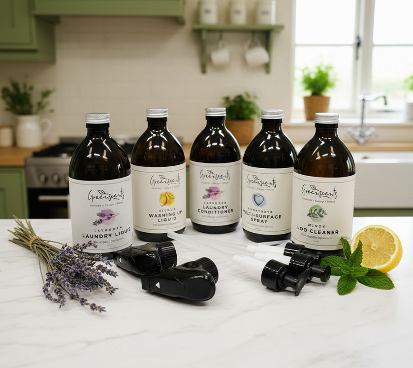 Set of Greenheart cleaning products on a kitchen counter with natural elements.