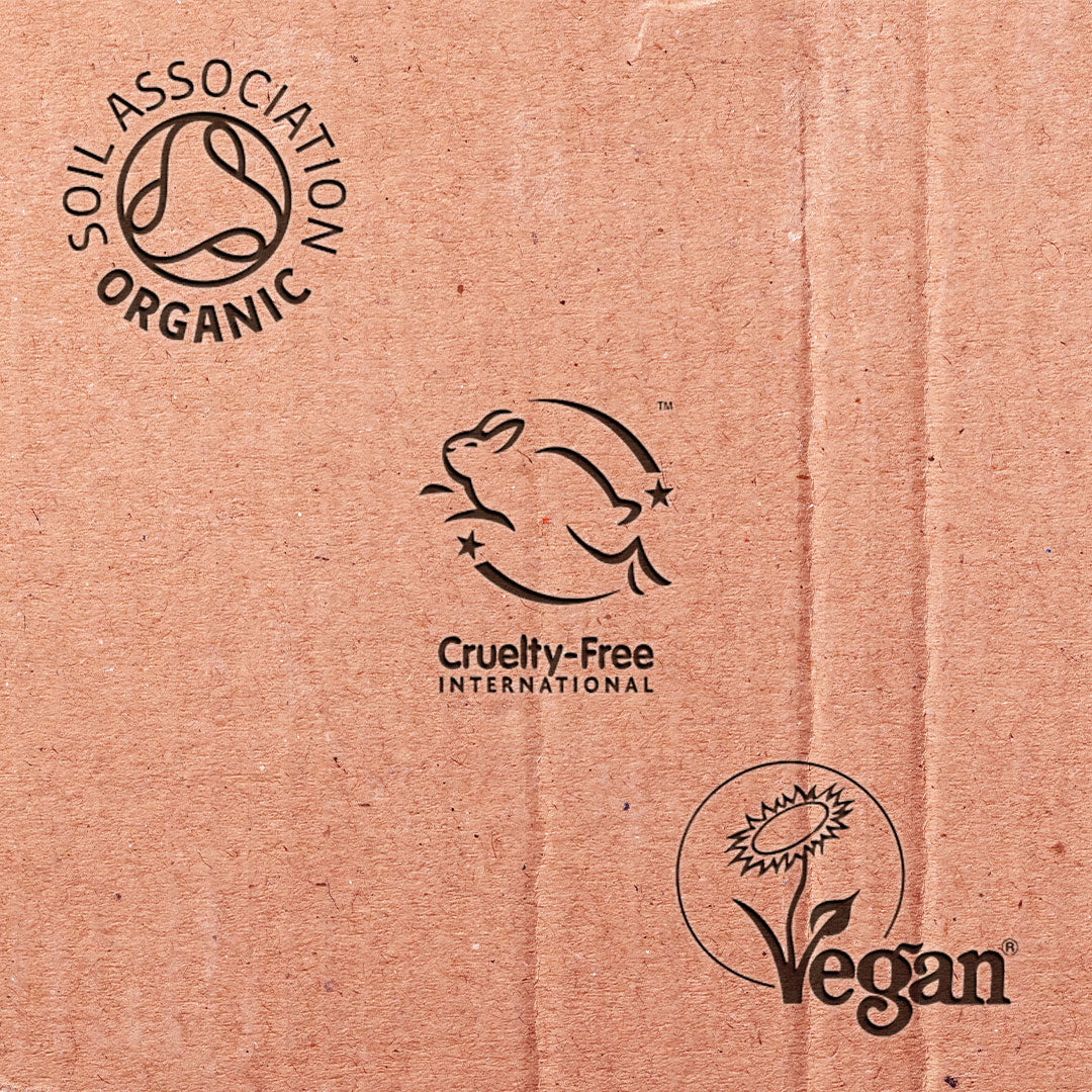 Cardboard surface with Soil Association Organic, Cruelty-Free International, and Vegan logos.